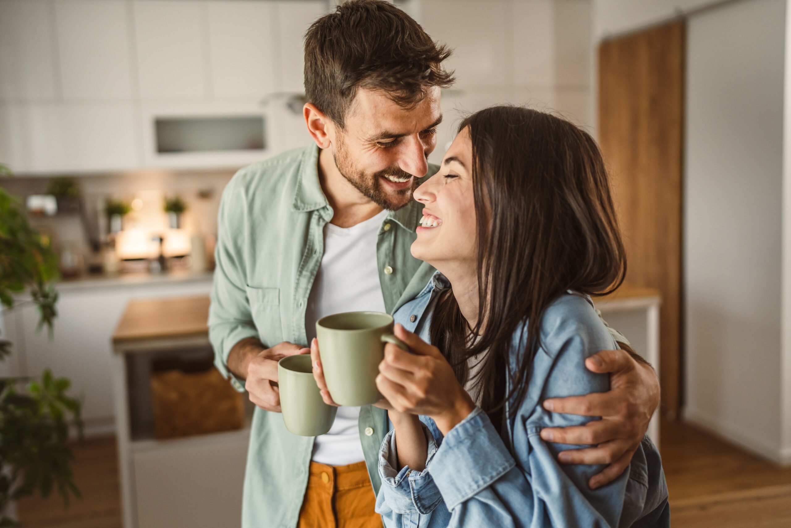 Couple drinking coffee and looking at a mobile phone