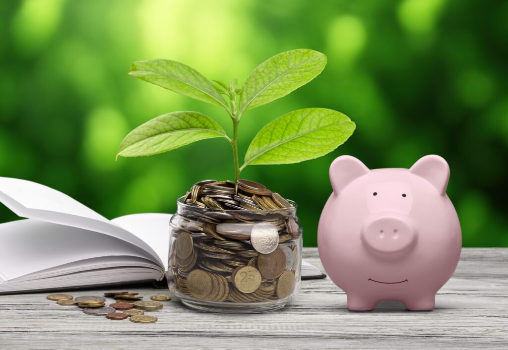 Glassful of coins and piggybank