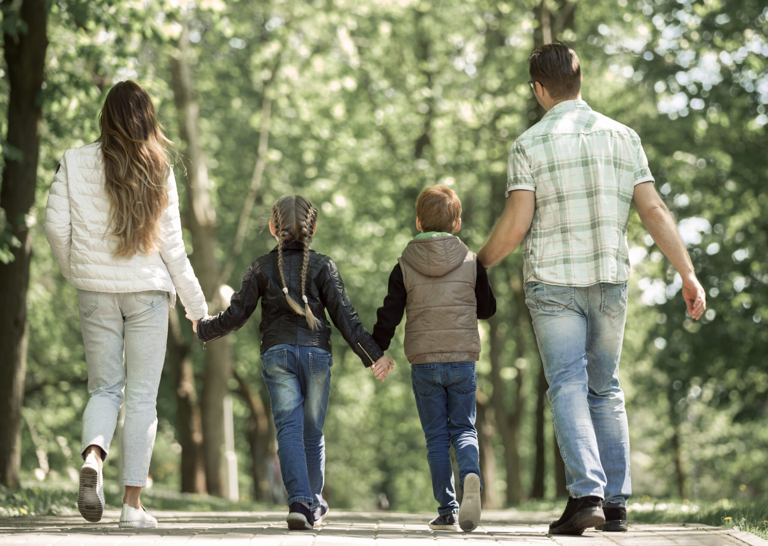 Young family walking in park